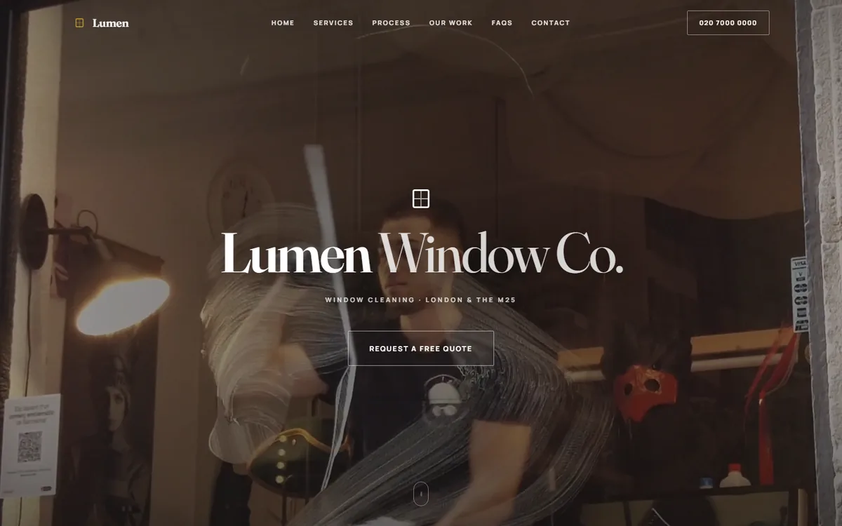 Lumen Window Co. homepage: a cleaner drawing a squeegee across a soaped shopfront window behind the centred wordmark.